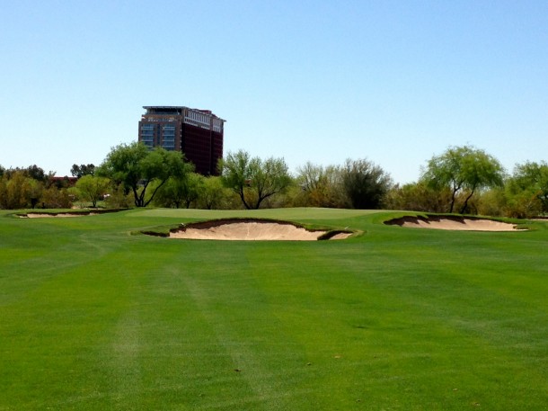 The green has a bunker placed about 10 yards in front of the putting surface and two more on either side.
